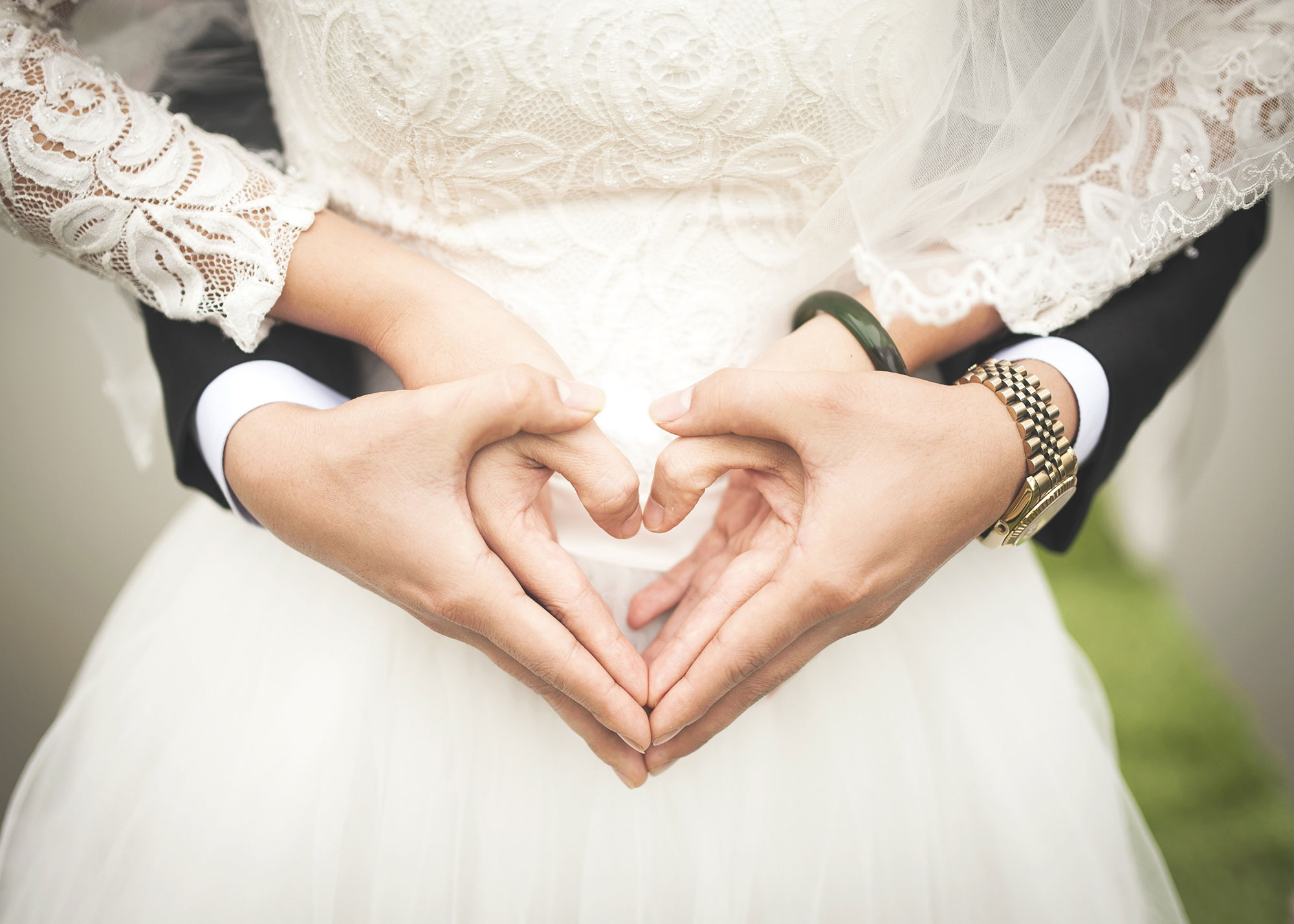 Couple forming a heart with their hands